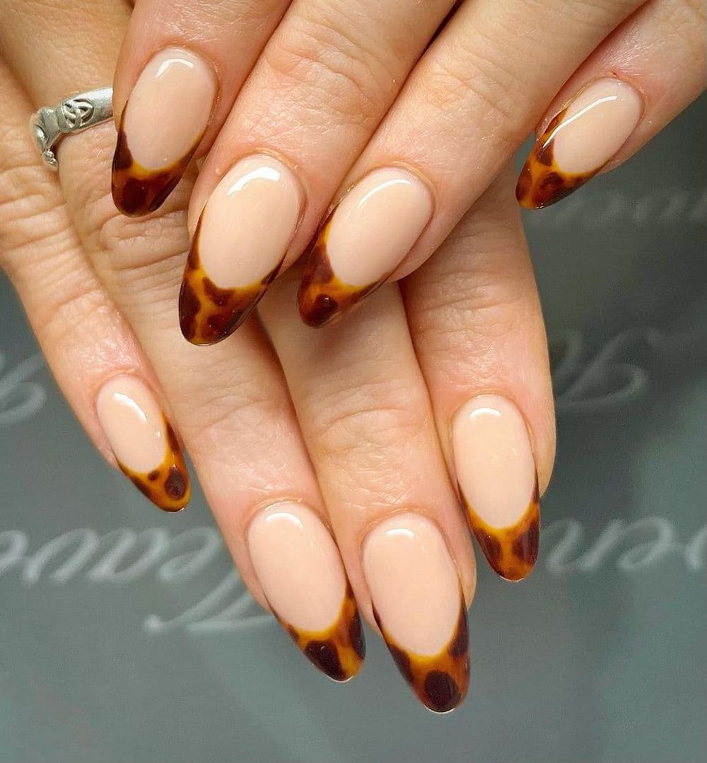 Tortoiseshell French tip nails, nude base with tortoiseshell amber tips on oval nails